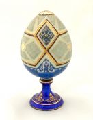 Hand Painted Porcelain Egg On An Enamelled Silver Stand, circa 1900