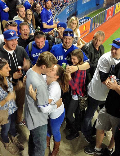 Happy Couple Engagement Ring Picture Blue Jays Game Smooch 