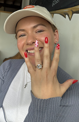 Auytmn is smiling showing her stunning vintage engagement ring, congratulations!